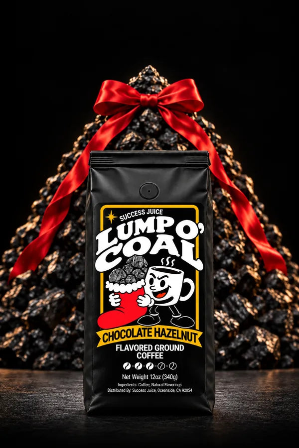 Lump O’ Coal coffee standing in front of a Christmas tree made of coal, tied with a red satin ribbon